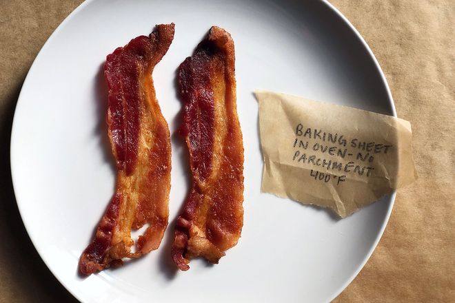 Bacon on a plate with a label: Baking Sheet in Oven - No Parchment 400 degrees F. The strips are slightly curled but mostly flat.